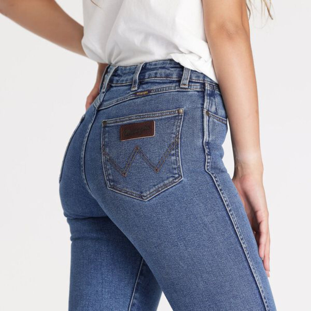 Durable denim texture and button-fly design on Wrangler Women's Straight Jean for everyday comfort.