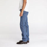 Side view showing straight leg fit on denim jeans