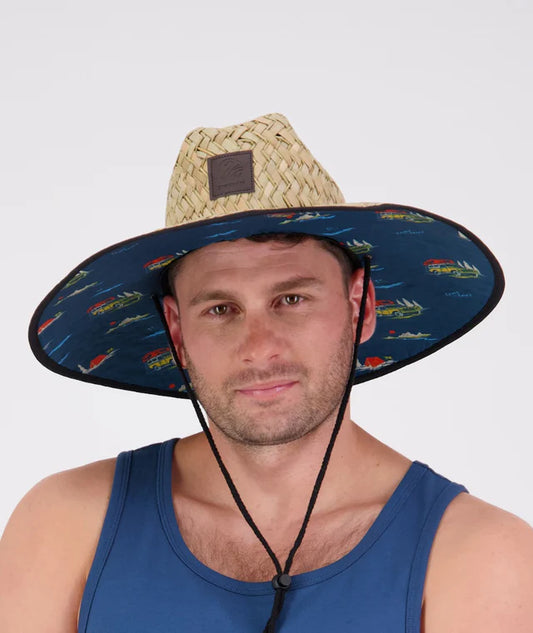 Swanndri Whangamata Straw Hat worn outdoors with UPF 50+ sun protection and adjustable chin strap for hiking or beach activities