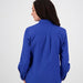 Slim-fit back design of women's blue long-sleeve button-up shirt, ideal for layering or standalone wear