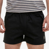 Front view of men's cotton navy rugby short with elastic waistband and deep side pockets.