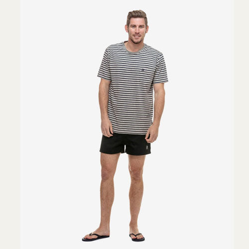 Model wearing men's cotton navy rugby short in outdoor setting, demonstrating casual style.