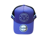 Side view of purple kids trucker cap with purple and white side stripe, white logo embroidery, and black mesh back by Outback Clothing Co.