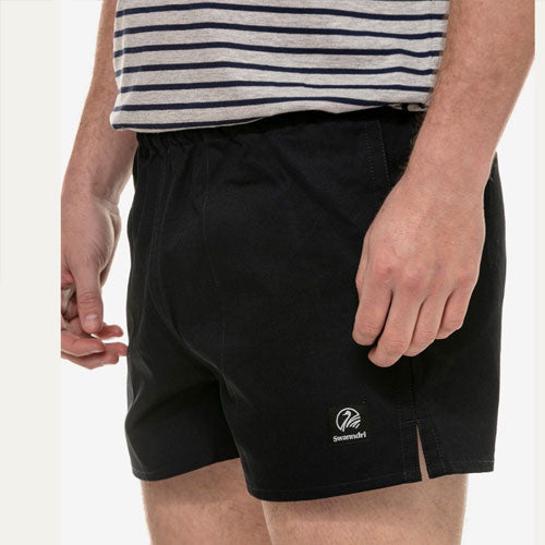 Side profile of men's navy rugby short showcasing relaxed fit and outer hem split.