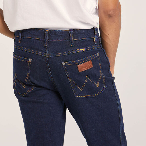 Durable denim texture of Wrangler Classics Men's Bootcut Jean – Faded wash with contrast stitching and copper rivets.
