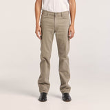 Wrangler leather patch logo on the waistband of camel-colored straight-leg moleskin jeans.