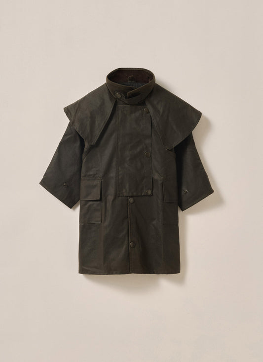 Child wearing Driza-Bone Kids Rider Coat, front view, waterproof brown oilskin outback jacket with detachable hood.