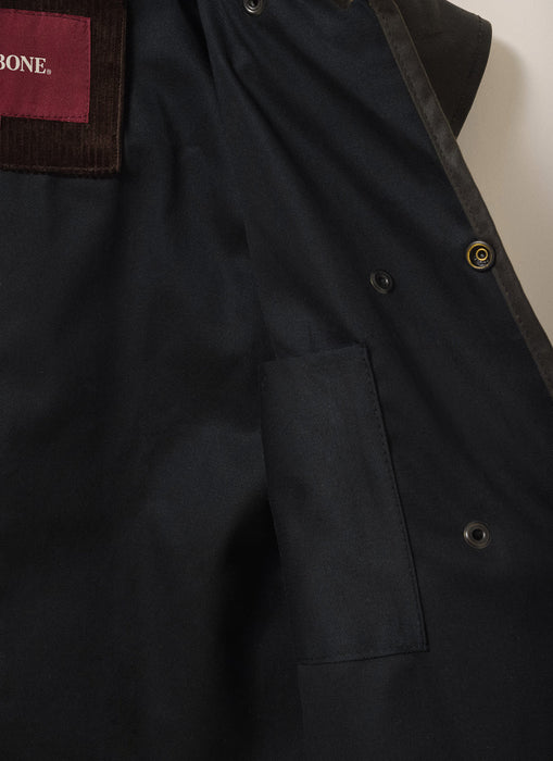 Close-up of the inside of Driza-Bone Kids Rider Coat showing soft cotton lining, internal pocket, and reinforced stitching for durability and warmth.