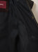 Close-up of the inside of Driza-Bone Kids Rider Coat showing soft cotton lining, internal pocket, and reinforced stitching for durability and warmth.
