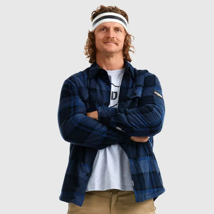 quirky model with crossed arms, close-up of blue flannel fabric