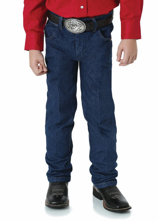 Front view of boy wearing Wrangler Junior Original ProRodeo Jeans in Prewashed Indigo, paired with a red shirt and dark boots.