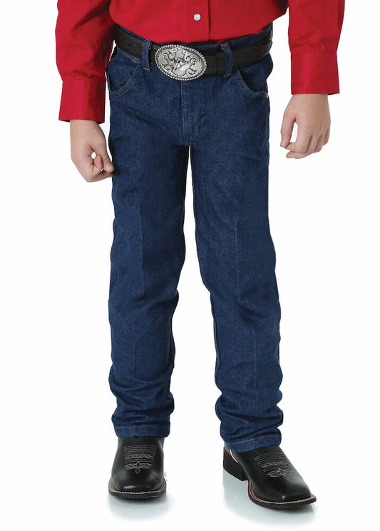 Front view of boy wearing Wrangler Junior Original ProRodeo Jeans in Prewashed Indigo, paired with a red shirt and dark boots.